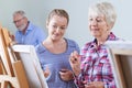 Seniors Attending Painting Class With Teacher Royalty Free Stock Photo