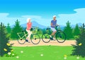 Elderly couple ride their bicycles along a forest path Royalty Free Stock Photo