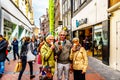 Seniors eating an ice cream cone in the busy Niewendijk shopping street in the historic center of Amsterdam