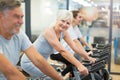 Seniors on exercise bikes in spinning class at gym Royalty Free Stock Photo