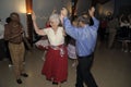 Seniors haviing fun dancing at a square Dance