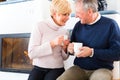 Seniors at home in front of fireplace Royalty Free Stock Photo