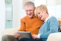 Seniors at home with tablet computer Royalty Free Stock Photo