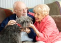 Seniors at Home with Their Dog Royalty Free Stock Photo