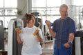 Seniors lifting weights at gym. Royalty Free Stock Photo