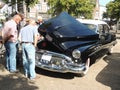 Seniors looking at a car