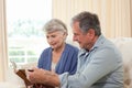 Seniors looking at their photo album Royalty Free Stock Photo