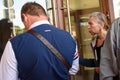 Seniors are looking into the window of PNB Bank in Riga.