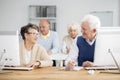 Seniors making friends during lecture Royalty Free Stock Photo
