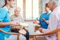 Seniors in nursing home making music with rhythm instruments
