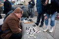 Seniors play chess on the street