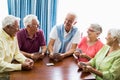 Seniors playing cards together Royalty Free Stock Photo