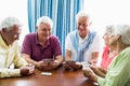 Seniors playing cards together Royalty Free Stock Photo