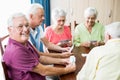 Seniors playing cards together Royalty Free Stock Photo