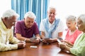 Seniors playing cards together Royalty Free Stock Photo