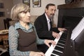 Seniors playing piano duet Royalty Free Stock Photo