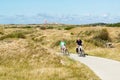 Seniors riding bicycles in dunes of Texel, Netherlands