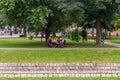 Seniors are sitting on a bench in a park in Loznica, Serbia.