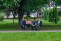 Seniors are sitting on a bench in a park in Loznica, Serbia.