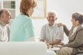 Seniors sitting with nurse