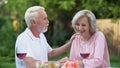 Seniors sitting at table and remembering their life together, happy marriage