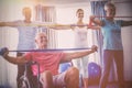 Seniors stretching during fitness class Royalty Free Stock Photo