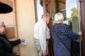 Seniors trying to open the entrance doors of PNB Bank. Riga, Latvia. Royalty Free Stock Photo