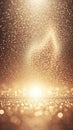 Golden Glittering Particles Falling and Rising from a Bright Light Source Creating a Bokeh Effect and a Sense of Celebration or Royalty Free Stock Photo
