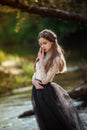 Sensitive art portrait of beautiful lonely girl in forest. Pretty woman posing outdoors and looking at you. Royalty Free Stock Photo