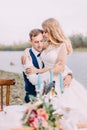 Sensitive outdoor portrait of the hugging newlywed couple. The beach location. Royalty Free Stock Photo