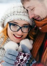 Sensitive outdoor winter portrait of the happy couple. The handsome man is hugging and holding hands of his girlfriend Royalty Free Stock Photo