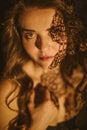 Sensitive sexy portrait of a girl with a lacy shadow on her face. Feminine and sexy. Mysterious atmospheric twilight