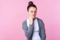 Sensitive teeth. Portrait of unhealthy teenage girl touching chin and frowning from terrible toothache. pink background Royalty Free Stock Photo