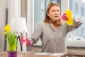 Housewife wearing gloves having sensitivity to cleaning detergents Royalty Free Stock Photo