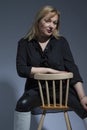 Sensual Alluring Mature Confident Caucasian Woman in Black Shirt With Hands Lifted On Dark White