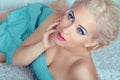 Sensual beautiful woman model with eyes makeup looking up, posing on bed Royalty Free Stock Photo