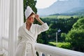 Sensual and beautiful woman in a white robe the balcony overlooks the mountains unaltered