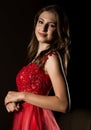 Sensual beautiful young woman posing in red dress in dark room. professional make-up Royalty Free Stock Photo