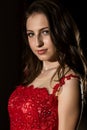 Sensual beautiful young woman posing in red dress in dark room. professional make-up Royalty Free Stock Photo