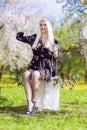 Sensual Blond Female Relaxing In Spring Forest on Swing. Royalty Free Stock Photo