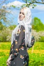 Sensual blond Woman in Kerchief Standing In Spring Forest Outside