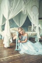 Sensual blonde woman in light blue tulle dress in luxurious vintage interior portrait Royalty Free Stock Photo