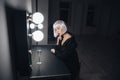 Sensual blonde woman sitting near mirror with glass of champagne Royalty Free Stock Photo