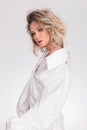 Sensual blonde woman wearing a bouffant white shirt