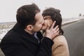 Sensual bride with windy hair and groom embracing on road. happy couple hugging  and kissing in wind, romantic tender and sexual Royalty Free Stock Photo