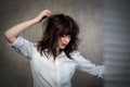 Brunette, girl in a shirt with shades of blinds on the body