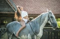 sensual brunette woman with sexy country look and horse. Portrait of a girl with brow lingerie and her horse Royalty Free Stock Photo