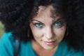 Sensual close-up portrait of young pretty woman with african curly hairstyle and nose piercing. Beautiful girl with