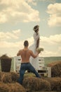 Sensual couple. Love, romance, relationship. Man give flowers to woman on bench. Macho with bare torso and girl with