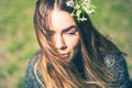 Sensual dreamy portrait of a spring woman, beautiful face female enjoying Cherry blossom, tree branch and natural beauty